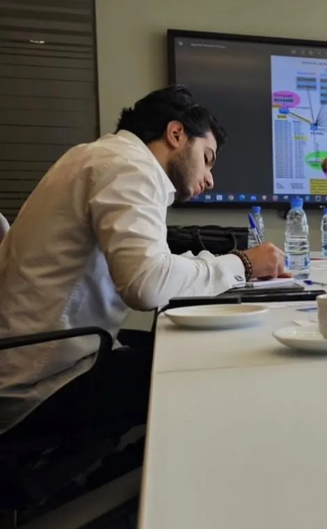 Ahmed taking notes during a network training session